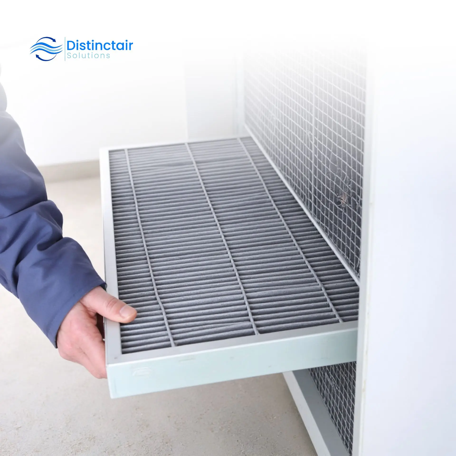 Hand changing the furnace filter in a home HVAC system