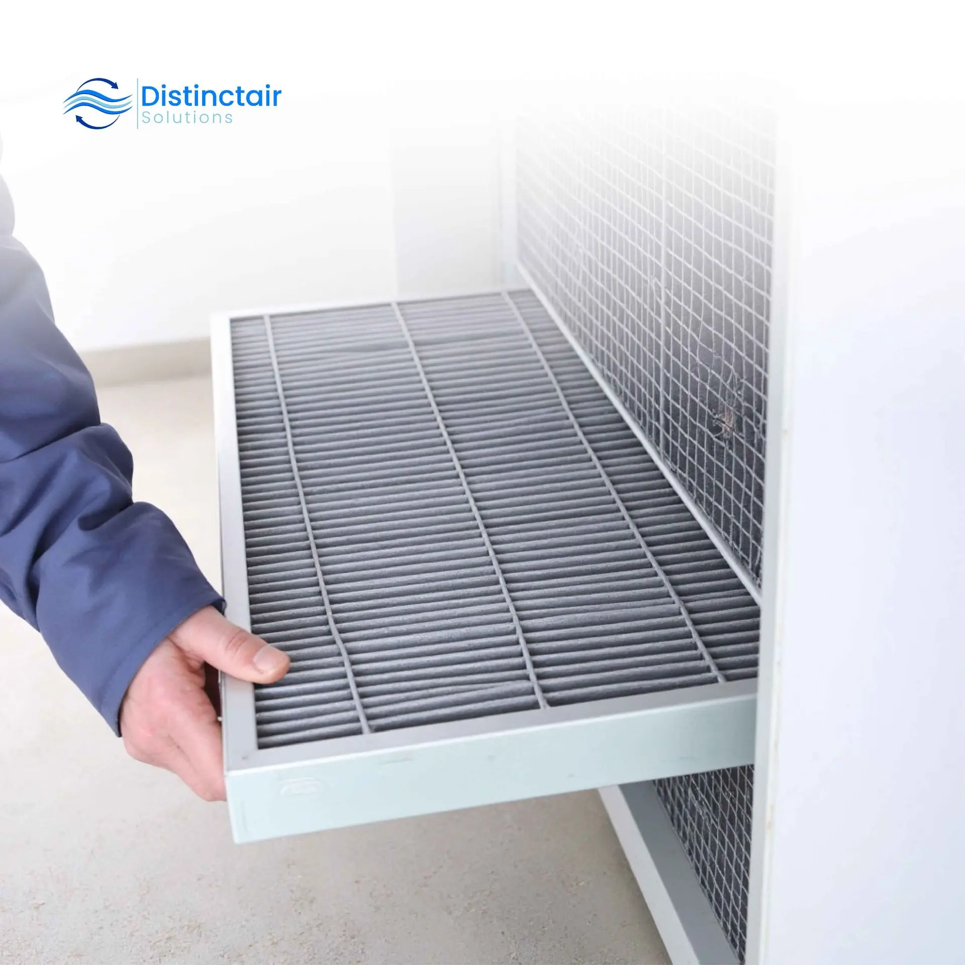 Hand changing the furnace filter in a home HVAC system